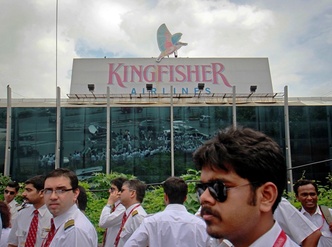 Striking employees stand in front of the Kingfisher Airlines office during a protest march against the company in Mumbai October 5, 2012. 