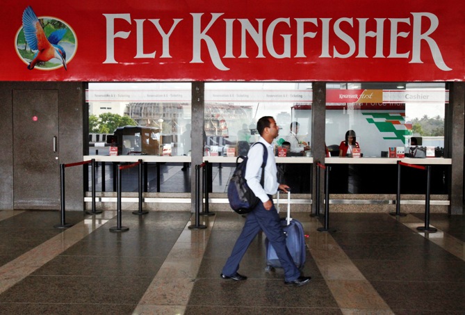 A passenger walks past a near-empty Kingfisher airlines ticketing office at Mumbai's domestic airport March 27, 2012.