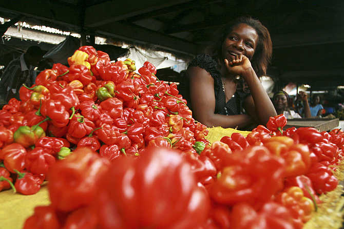 A vendor stands behind her vegetables on sale at a market in Calabar, Delta region, Nigeria.