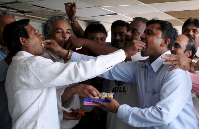 Traders eat sweets inside a brokerage in Ahmedabad.