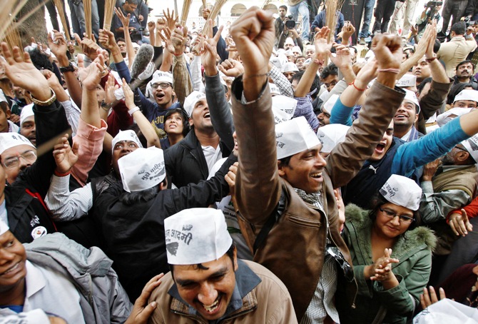 Supporters of Arvind Kejriwal, leader of the newly formed Aam Aadmi Party, celebrate after Kejriwal's election win.