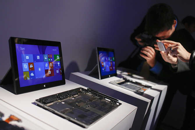 Members of the media take pictures of Surface 2 tablets in New York.