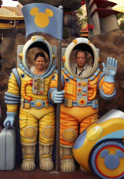 An expat couple poses at Hong Kong Disneyland.