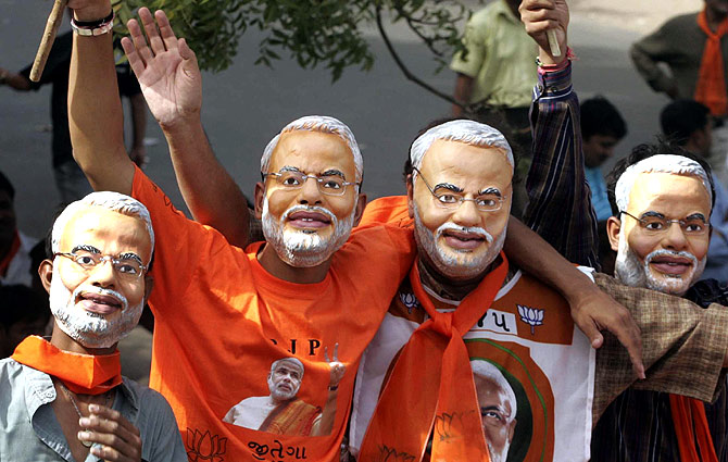 Supporters of Bhartiya Janta Party (BJP) wear masks of Gujarat's Chief Minister Narendra Modi. 