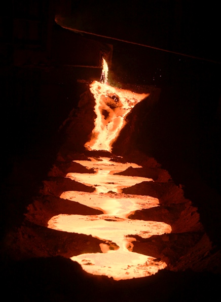 Molten steel flows from a submerged arc furnace inside a steel factory on the outskirts of Jammu.
