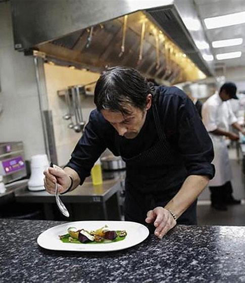 Matteo Boglione, executive chef of Le Cirque Signature restaurant, prepares a dish inside the kitchen.