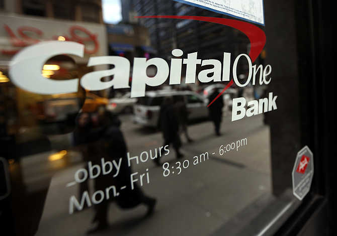 People walk past a Capital One banking centre in New York's financial district.