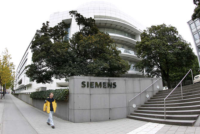 A man passes by Germany's Siemens headquarter in Munich.