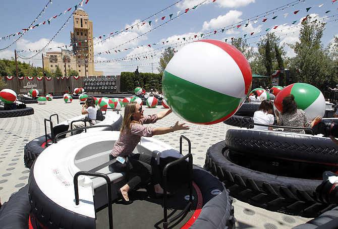 Expanded Disneyland California Adventure Park features Luigi's Flying Tires, air vents that drive guests in vehicles of oversized tyres to float above the ground, bumping other tyres to catch an inflatable ball at the park in Anaheim, California.