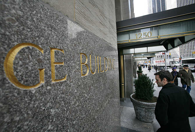 A man enters the General Electric building at 1250 Avenue of the Americas in New York.