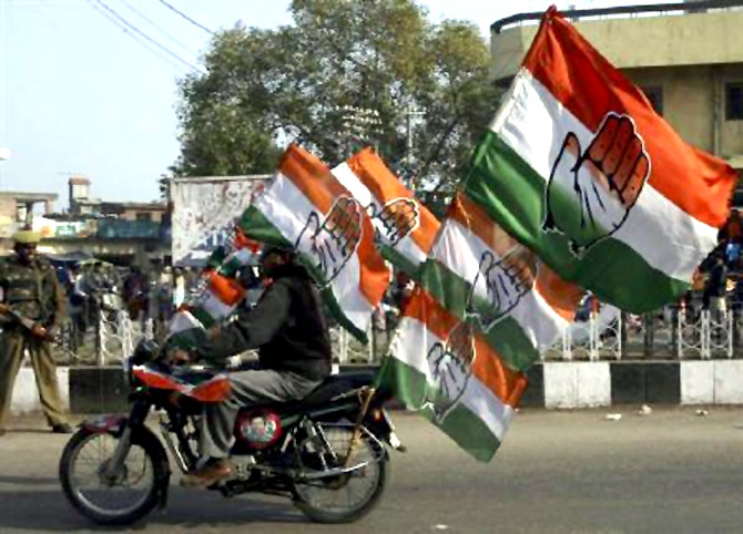 A supporter of India's ruling Congress party rides a motorbike in Jammu.