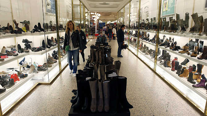 People browse through a shoe shop in central Barcelona, Spain.