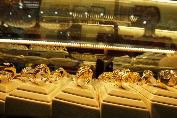 Gold products are displayed for sale at a shop.