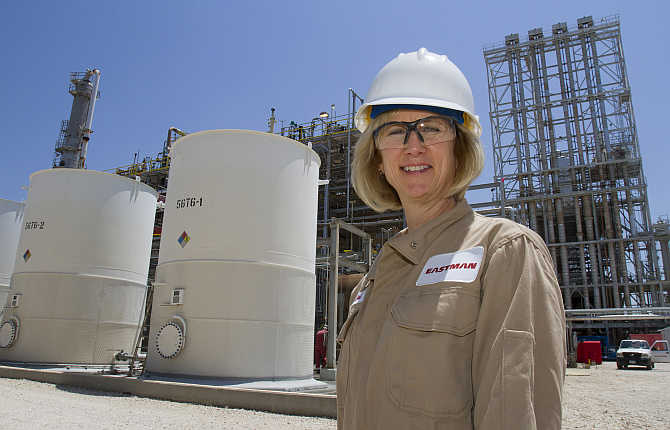 Eastman Chemical site manager and chemical engineer Cari Parker in front of tanks of plasticizer product at the plant in Texas City, Texas.