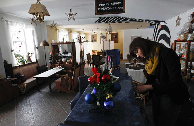 A waitress prepares coffee at a Seventh Heaven restaurant in the centre of the Town of Pabianice, Poland.