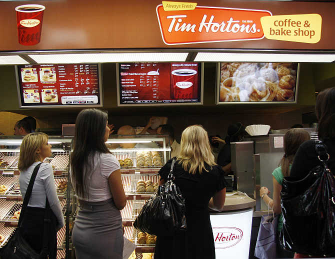 Customers wait at a Tim Hortons coffee and bake shop at Penn Station in New York.