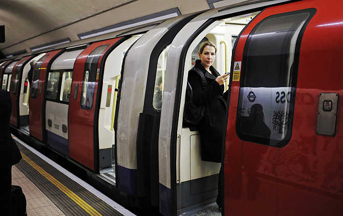 A woman waits for a tube train to depart at an underground station in London, United Kingdom.