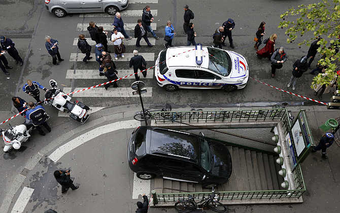 Police gather at the entrance to the Chaussee d'Antin La Fayette Metro station after a car accidentally drove into it in Paris, France.