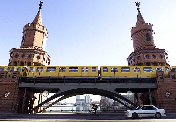 A historic underground train passes an elevated section of the network in the centre of Berlin, Germany.
