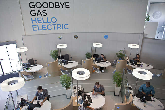 Workers sit at their desks at the headquarters of electric car venture Better Place in Tel Aviv, Israel.
