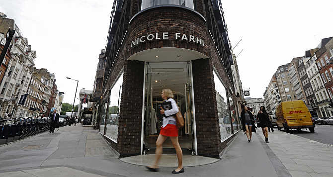 Pedestrians walk past a branch of fashion chain Nicole Farhi in central London, United Kingdom.
