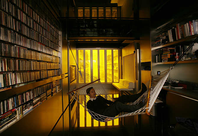 Architect Gary Chang rests in a hammock inside his apartment in Hong Kong.