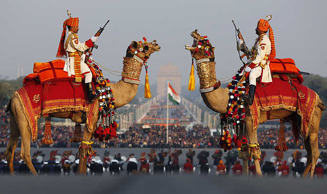 Border Security Force soldiers ride their camels as they rehearse for the 'Beating the Retreat' ceremony in New Delhi.