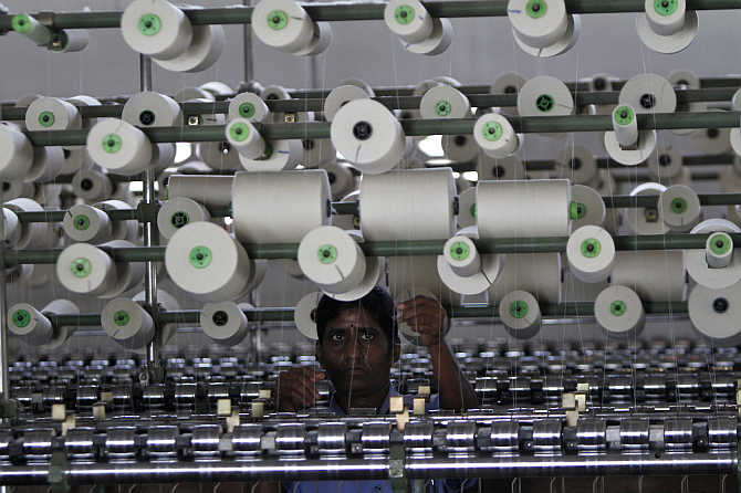 A worker tends to yarn-spinning equipment at a factory in Coimbatore.