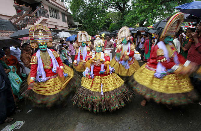 Dancers perform as they take part in festivities marking the start of the annual harvest festival of Onam in Kochi.