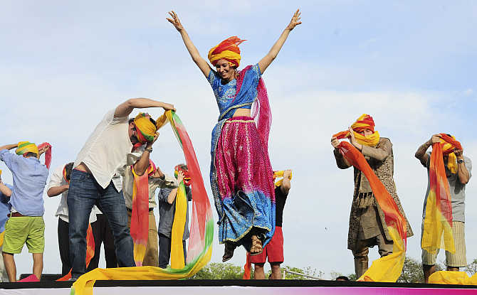 A tourist celebrates after finishing first in a turban tying competition in Jaipur.