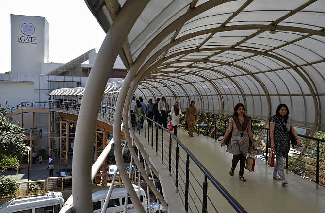 Employees cross an overpass at the Indian headquarters of iGate in Bangalore.