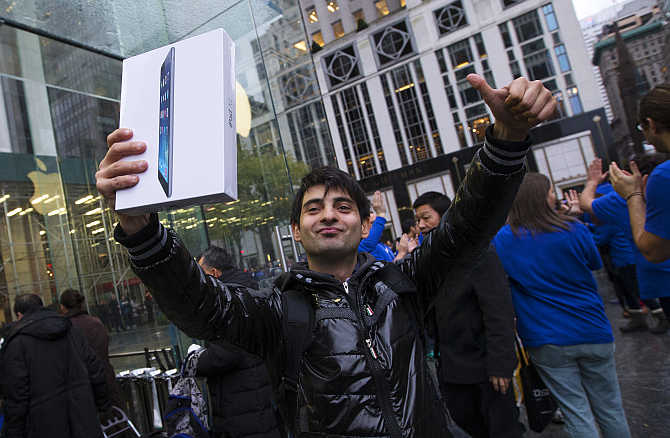 Rami Shamis celebrates outside the Apple Store on New York's Fifth Avenue after buying an iPad Air.
