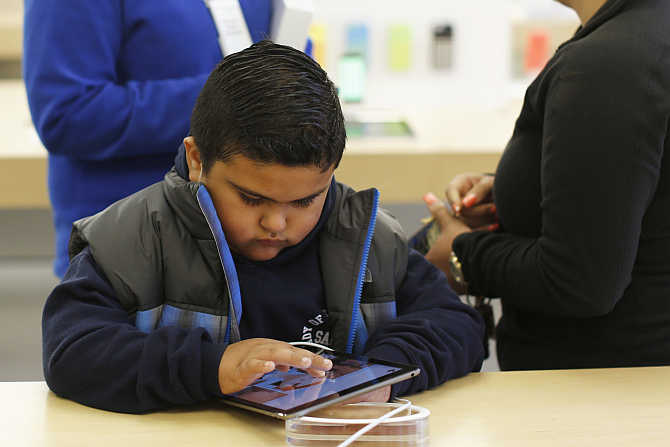 A child uses an iPad Air tablet at the Apple store in San Francisco, California.