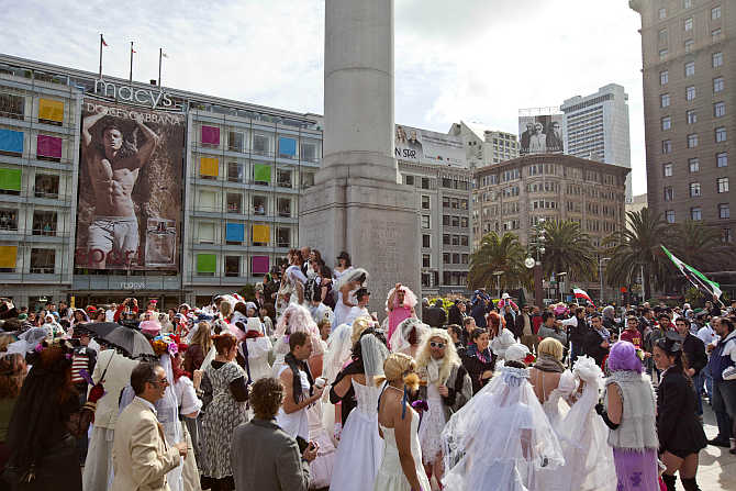 Participants, dressed in bridal outfits, gather in Union Square during the March of Brides parade through downtown San Francisco.