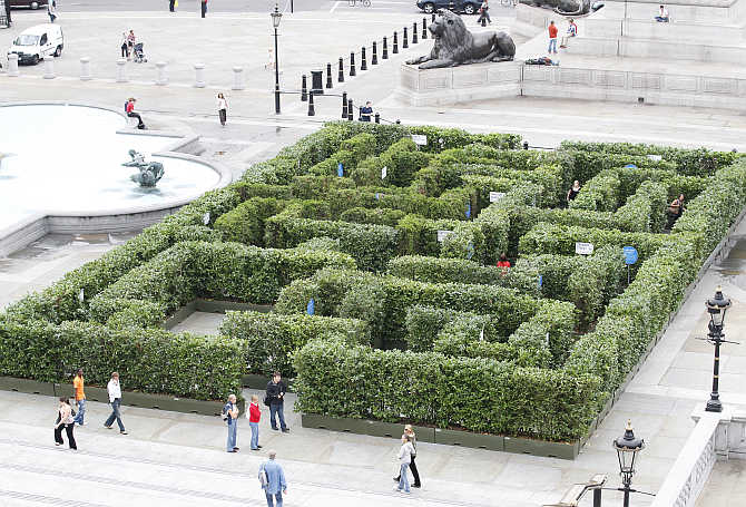Visitors walk past a maze which has been set up in Trafalgar Square to promote London's West End shopping and entertainment district.