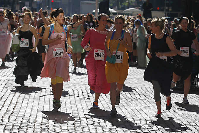 Participants leave the starting line at the annual Running with The Bridesmaids event in Boston, Massachusetts.