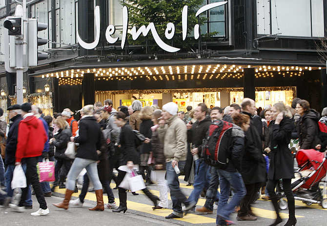 People walk past the Jelmoli department store on Zurich's main shopping street Bahnhofstrasse.