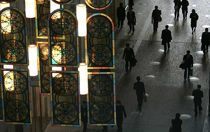 Office workers walk under a decorated illumination in Tokyo's Marunouchi business district.