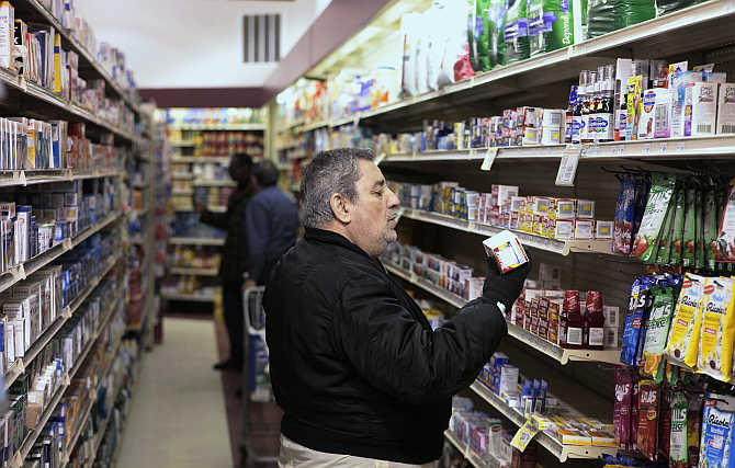 A customer takes a look at medication on a shelf at a pharmacy in New York.