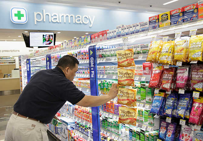 A worker stocks a Walgreens store in Chicago.