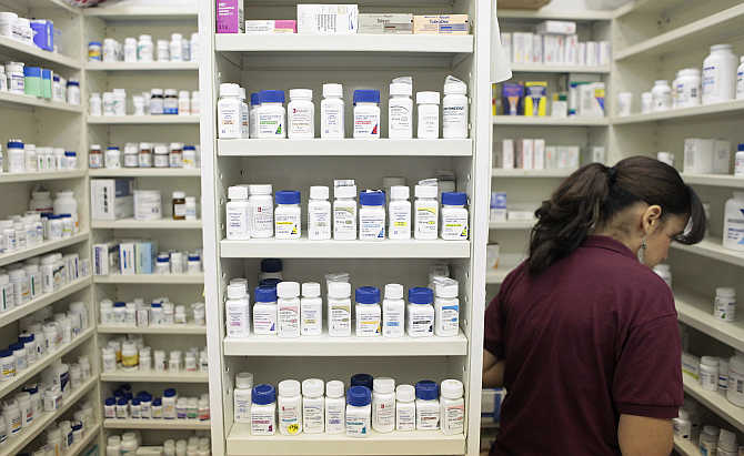 An employee looks for medication at a pharmacy in New York.