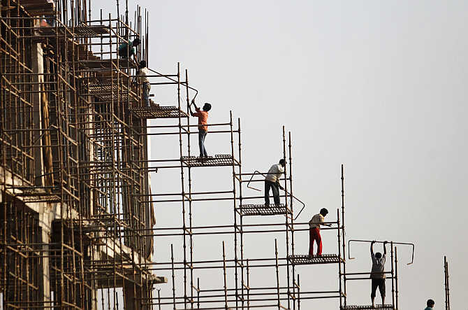 Labourers work at the construction site of a commercial complex in New Delhi.
