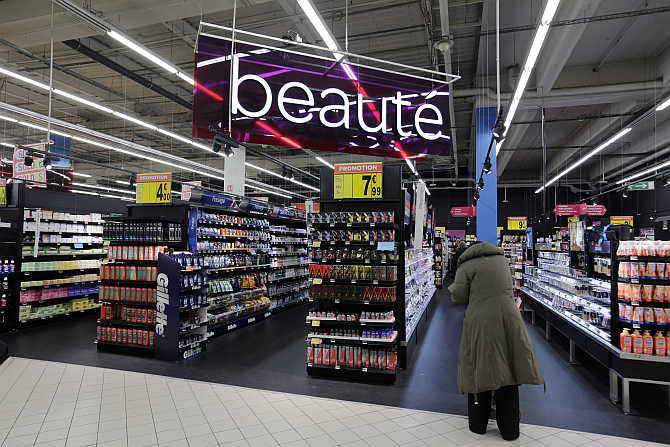 A customer stands in front the Beauty department at Carrefour's Bercy hypermarket in Charenton, a Paris suburb.