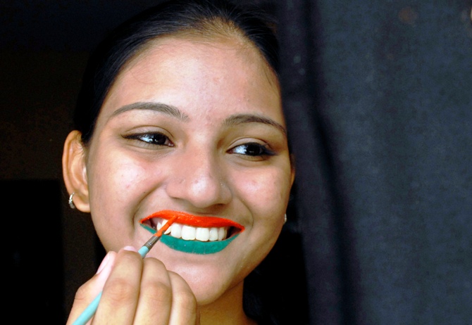 A woman has her lips painted in tri-colours of India's national flag ahead of the Independence Day celebrations.