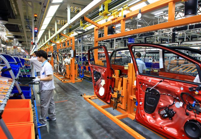 Employees work on the production line of new Golf sedan at a plant of FAW-Volkswagen Automotive Company.