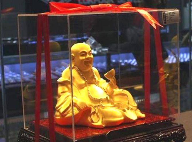 A gold Buddha statuette is seen inside a Luk Fook Jewellery shop in Yichang, Hubei province, May 20, 2012.