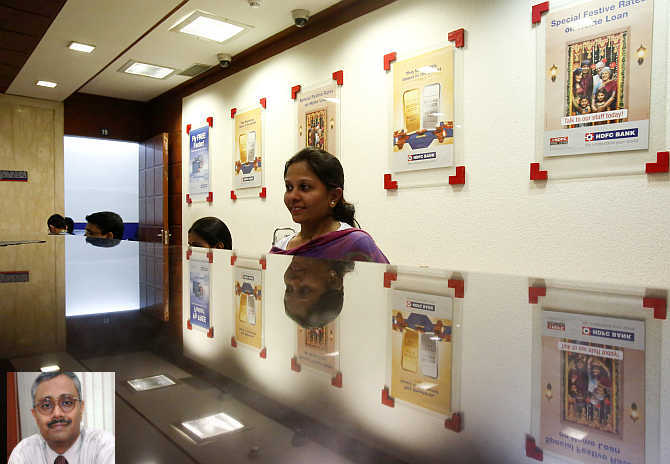 A teller waits for customers at a counter in a HDFC Bank branch in Mumbai. Inset, Paresh Sukthankar.