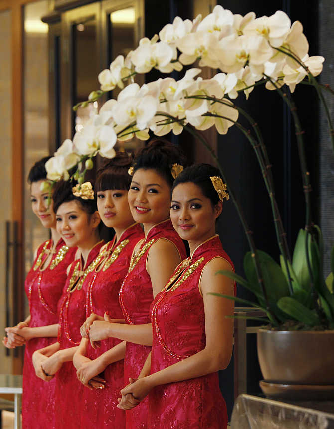 Attendants welcome guests inside Galaxy Macau, a resort in Macau.