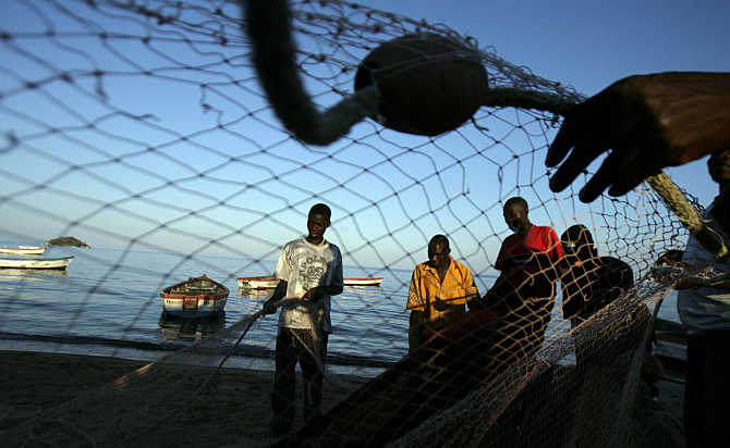 Fishermen prepare their nets on the banks of Lake Malawi about 100km east of the capital Lilongwe, Malawi.