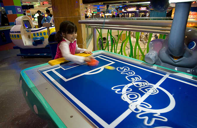 A girl plays a game at the Wonderland fun centre in north western Tehran, Iran.
